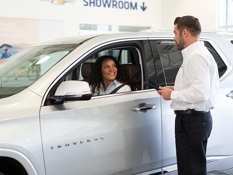Chevrolet salesman showing someone a new car