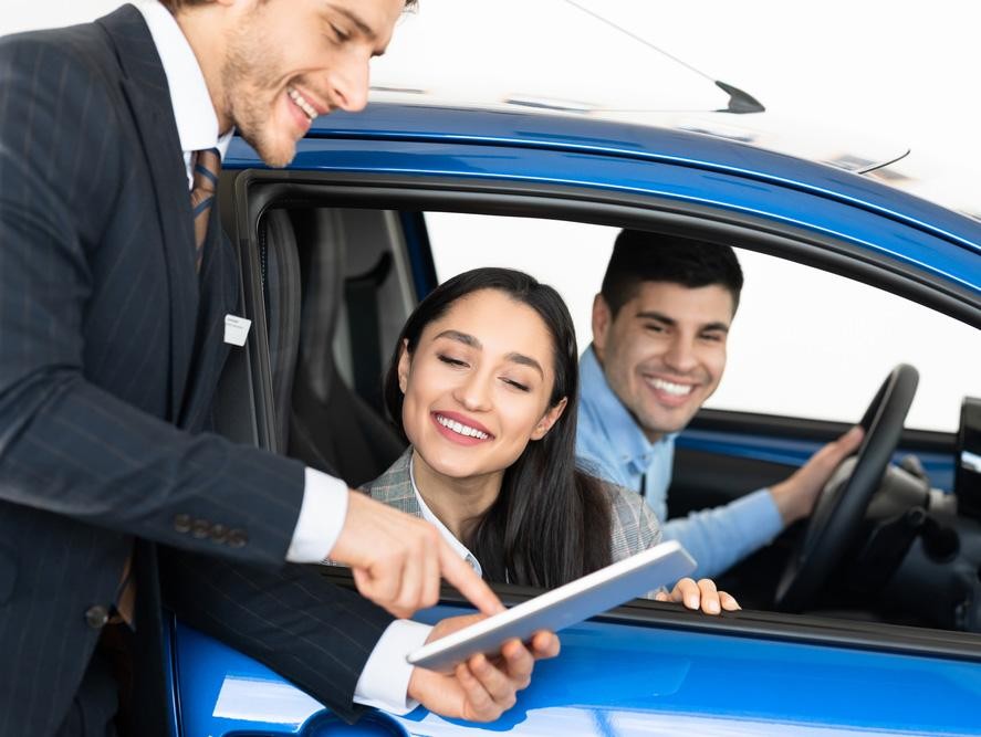 Car salesman showing customer paperwork