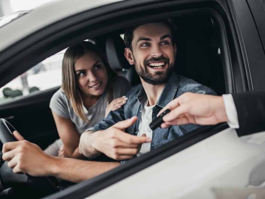 Couple getting the keys to their new car