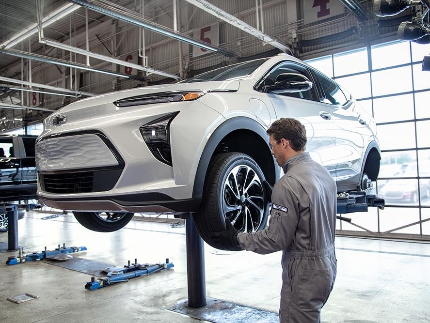 Chevrolet service technician replacing a tire
