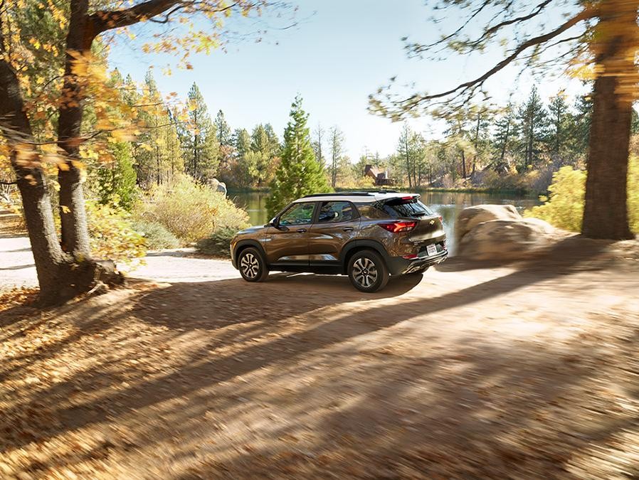 2021 Tahoe driving through a wooded area