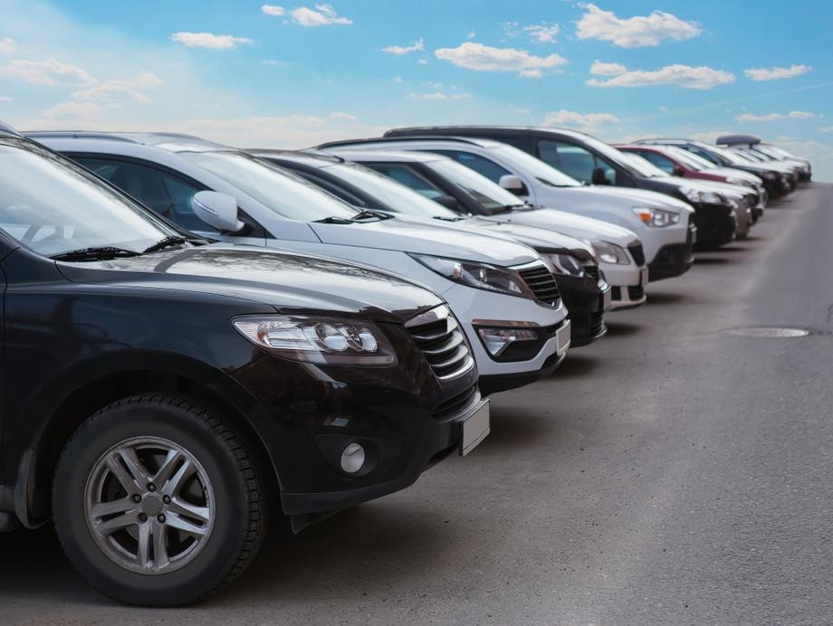 Used cars parked in a line on a lot
