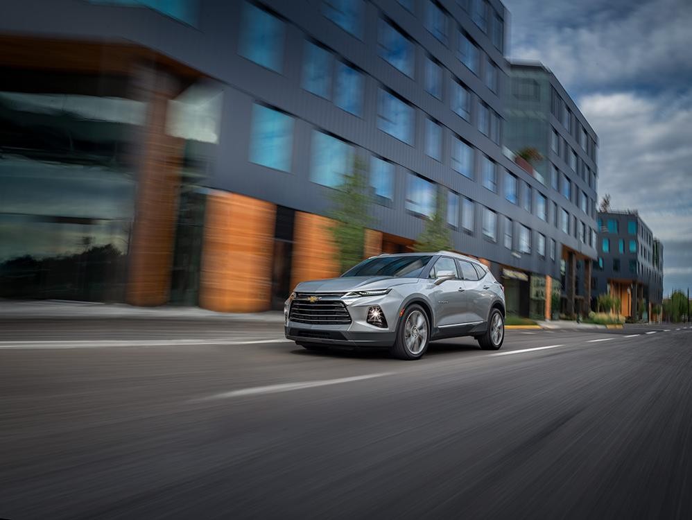 Chevrolet Blazer SUV on the road with buildings in the background
