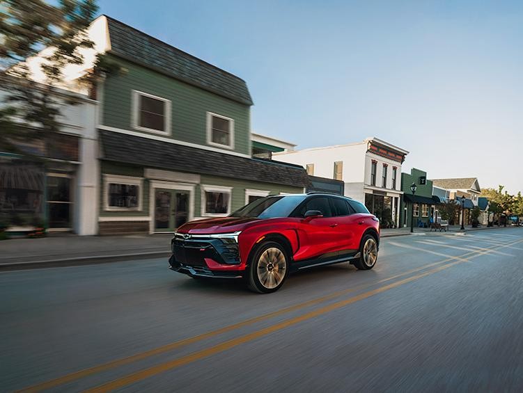 2025 Chevy Blazer EV driving past stores
