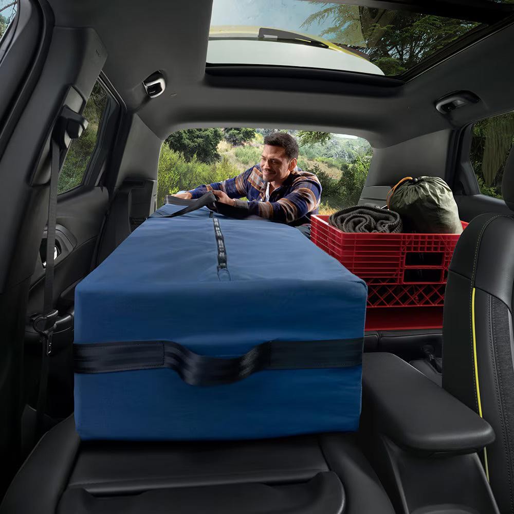 Man loading cargo into the 2025 Chevy Trailblazer
