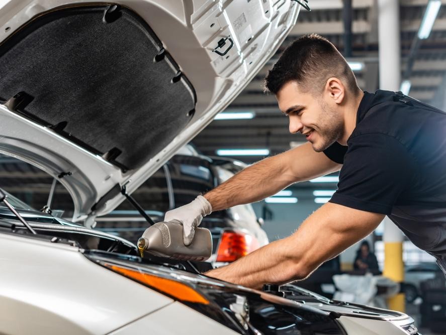 Service technician doing an oil change