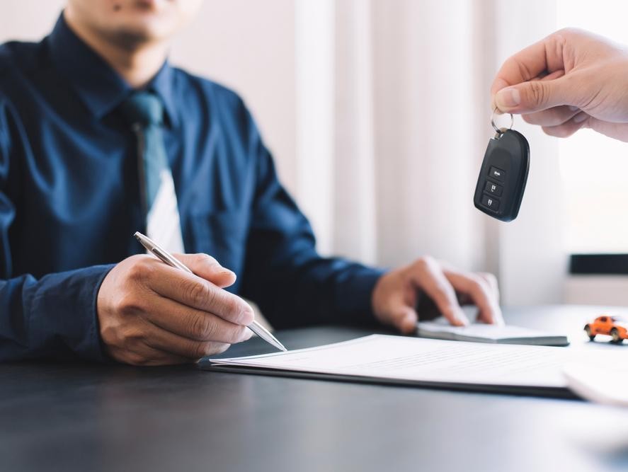 Signing papers for the purchase of a car