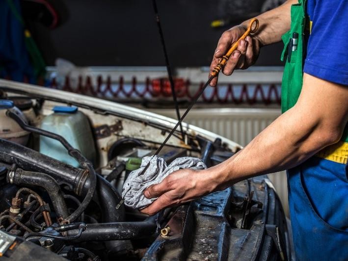 Mechanic checking oil at Lawrence Chevrolet