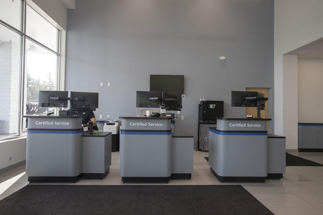 Father and son talking to service technician