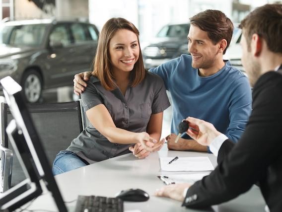 A couple financing a vehicle at dealership