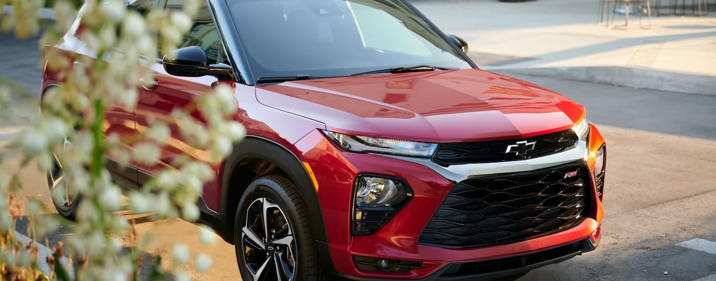 A red 2023 Chevy Trailblazer is shown parked on the side of a city street.