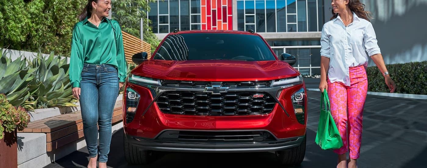 A red 2025 Chevy Trax is parked outside of a Chevy dealer near Opelousas.