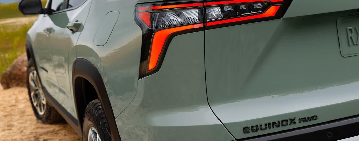 The brake light and rear side of a green 2025 Chevy Equinox ACTIV.