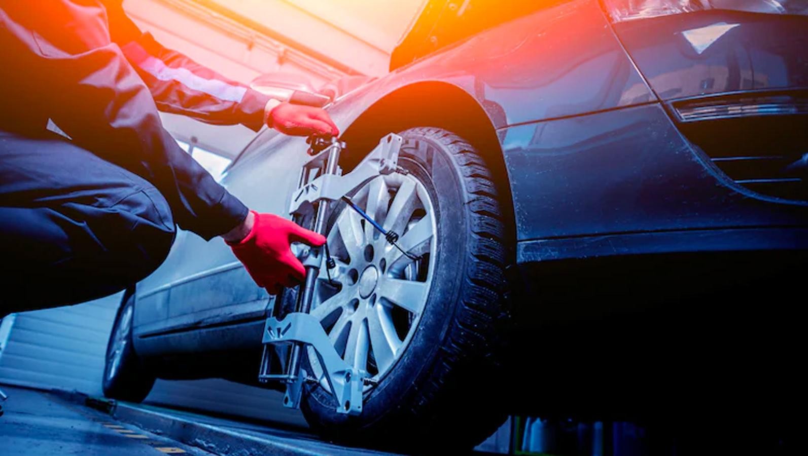 Service technician looking after car tire