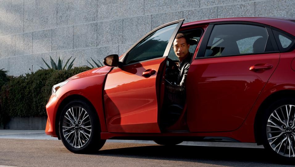 Man in Red Kia car