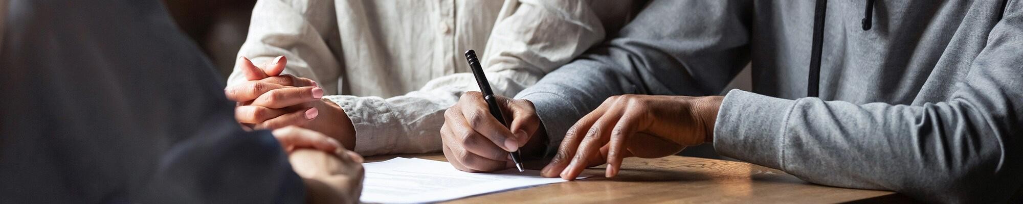 Clients are signing the paper. Clients are signing the paper.