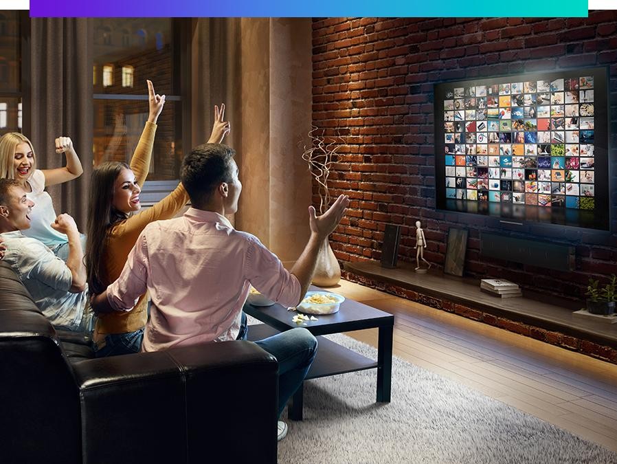 group of people watching tv on a couch