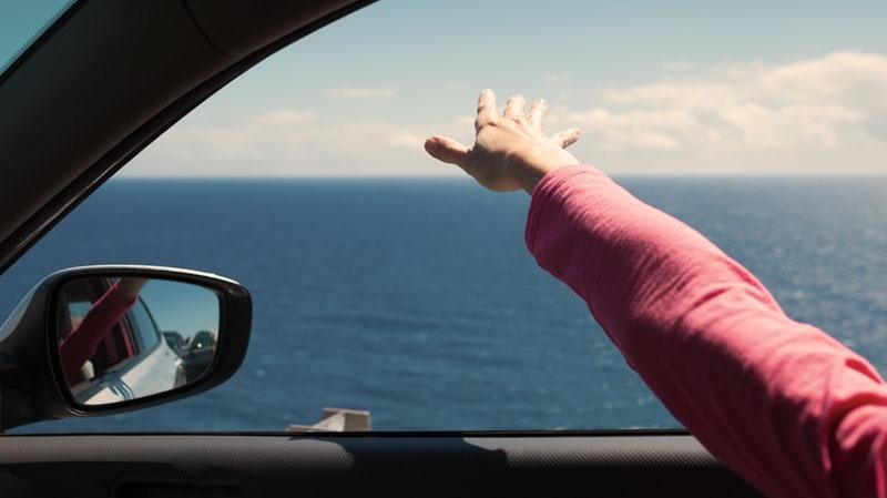 Womans hand out car window