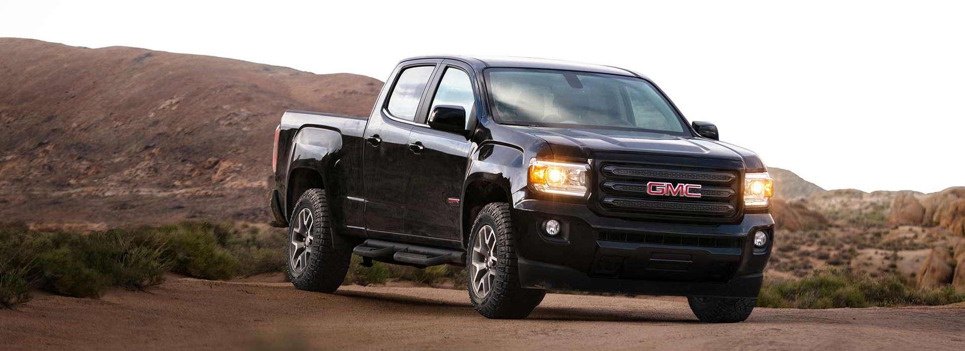 A black 2018 GMC Canyon parked in the desert