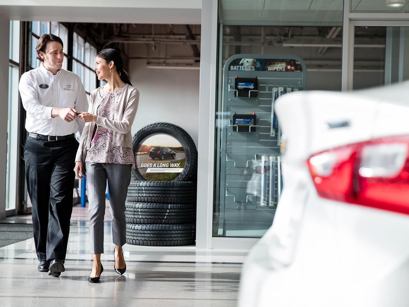 Buick, Chevrolet, GMC Certified Service Employee handing keys to women.