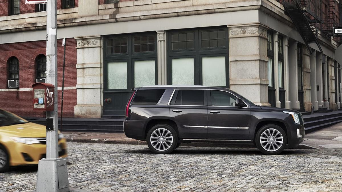 2018 Cadillac Escalade Exterior view of vehicle parked on city street in front of buildings.