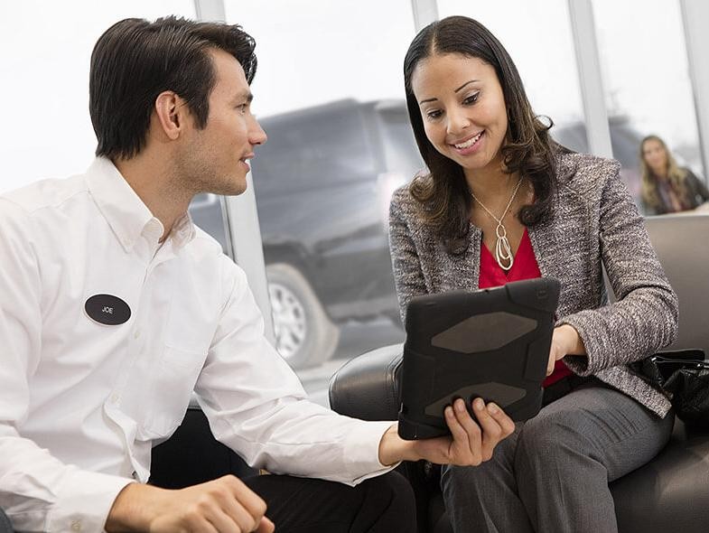 Photo of sales associate working with a customer.