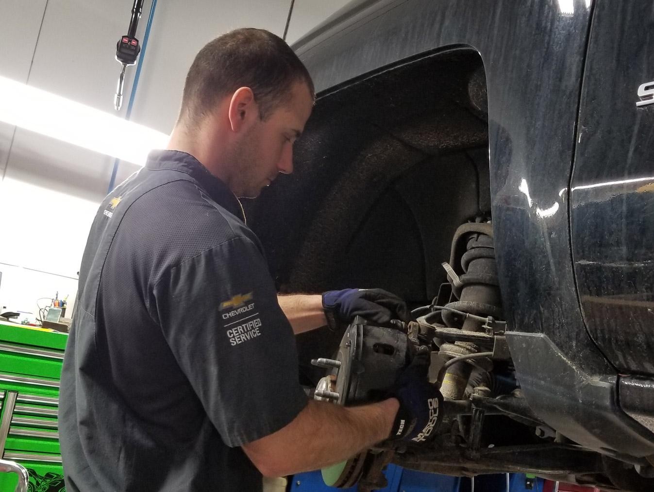 Service technician changing brake pads