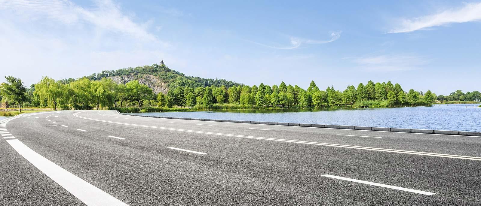Background Image | Road Lined with Water and Trees