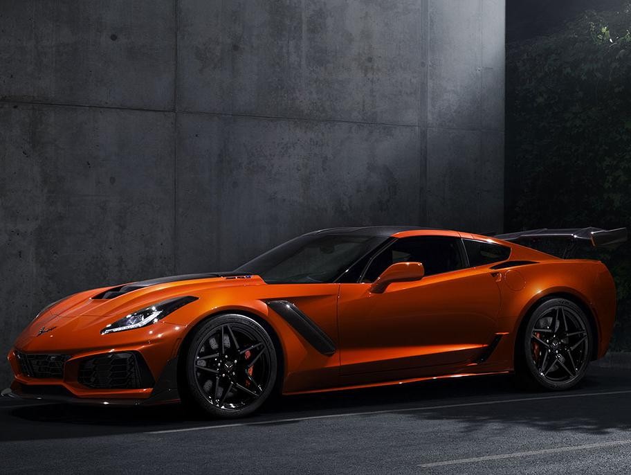 A Sebring Orange 2019 Chevy Corvette parked in a pool of moonlight.