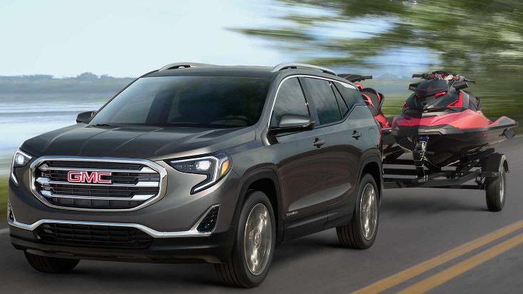 A 2018 GMC Terrain towing two jet skis