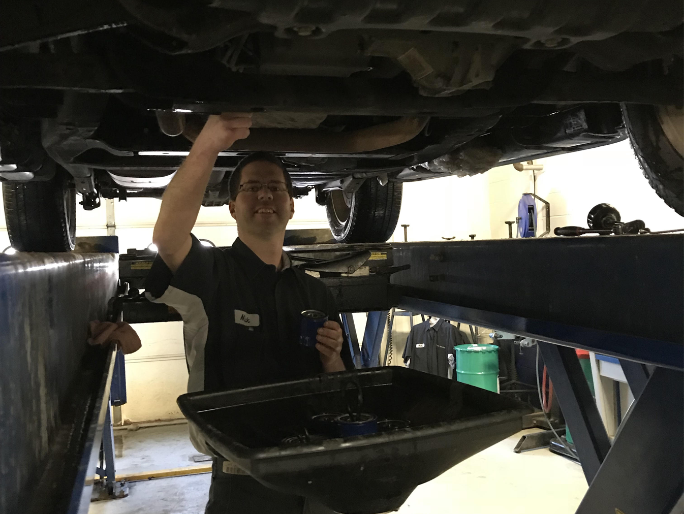 Service technician checking vehicle oil
