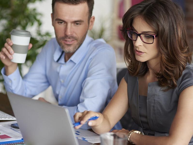 Couple working on their laptop at home.