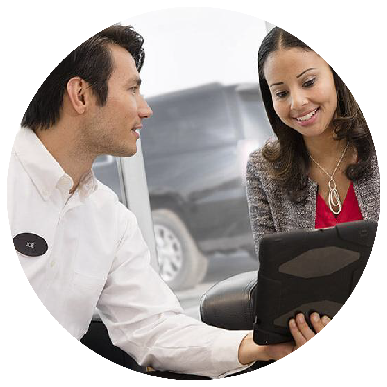 Woman at a customer service desk helping a man with a transaction.