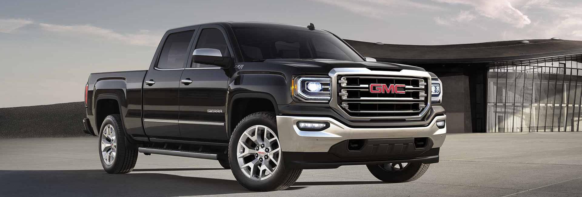 A black 2018 GMC Sierra 1500 parked on an industrial worksite 