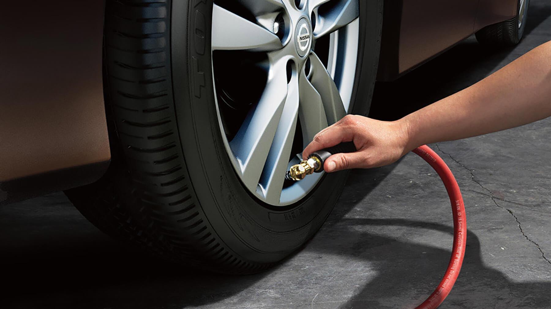 Nissan Technician Filling up a Tire