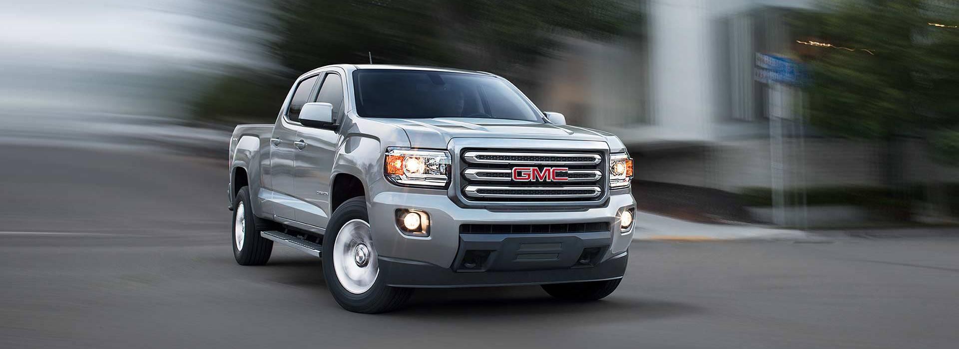 A silver 2018 GMC Canyon turning fast