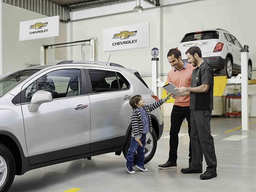 Father and son talking to service technician