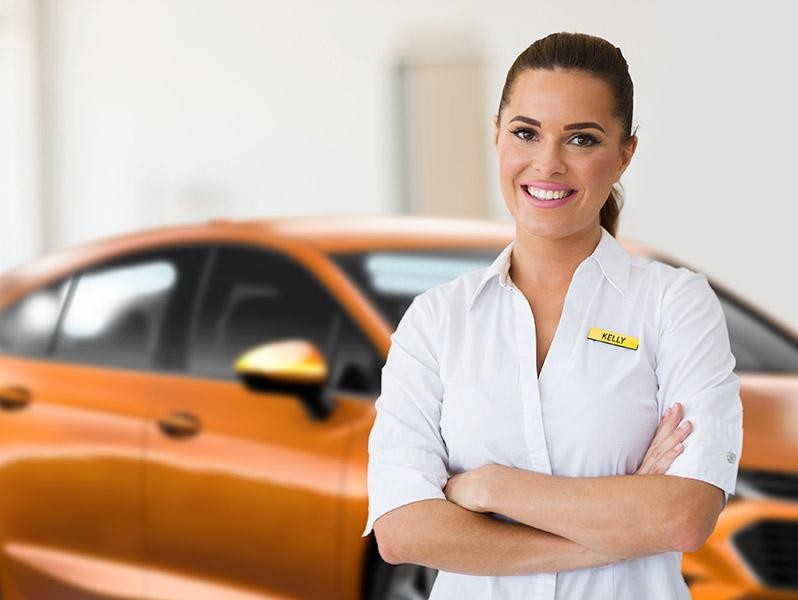 Smiling woman Chevy customer service representative in a dealership.