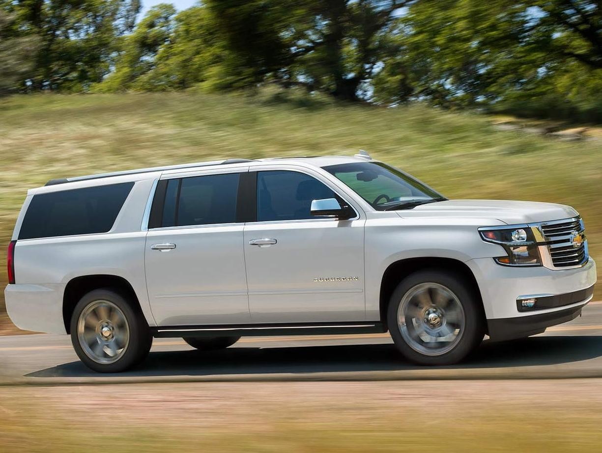 White Chevy 2019 Suburban driving on a road