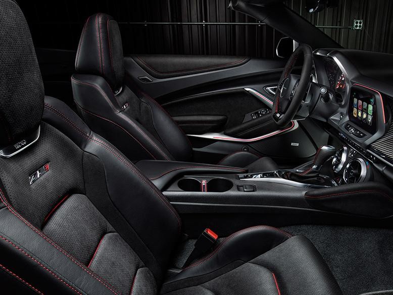 Interior of the Chevy Camaro ZL1 in black and grey with red stitching.