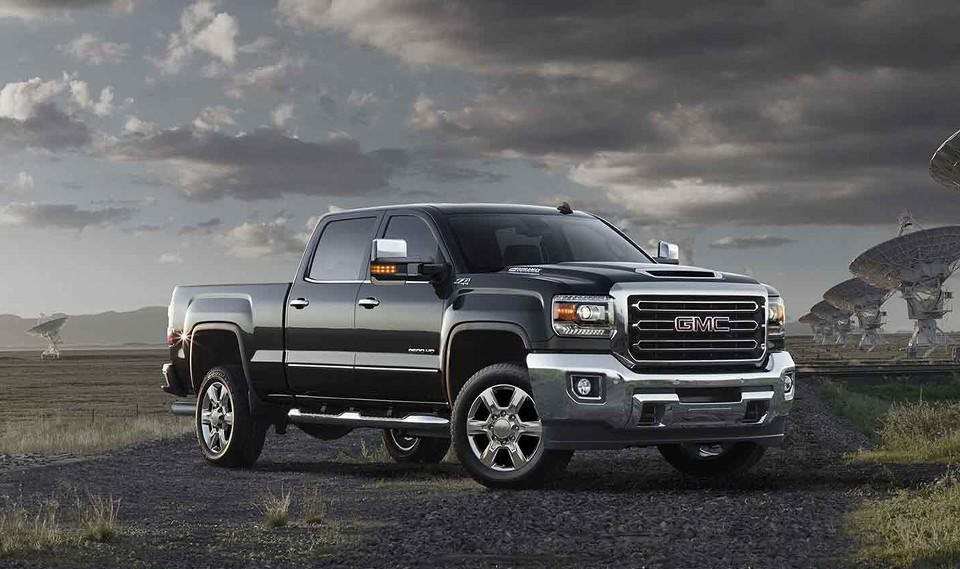 A black 2018 GMC Sierra 2500HD parked near satellite dishes 