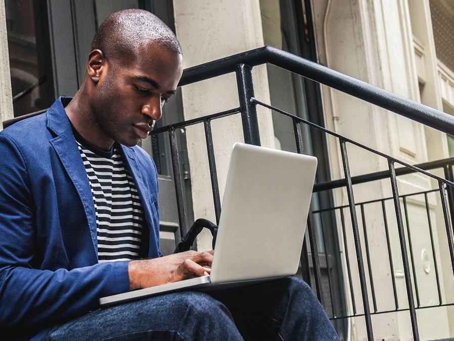 Man on stairs shopping online.