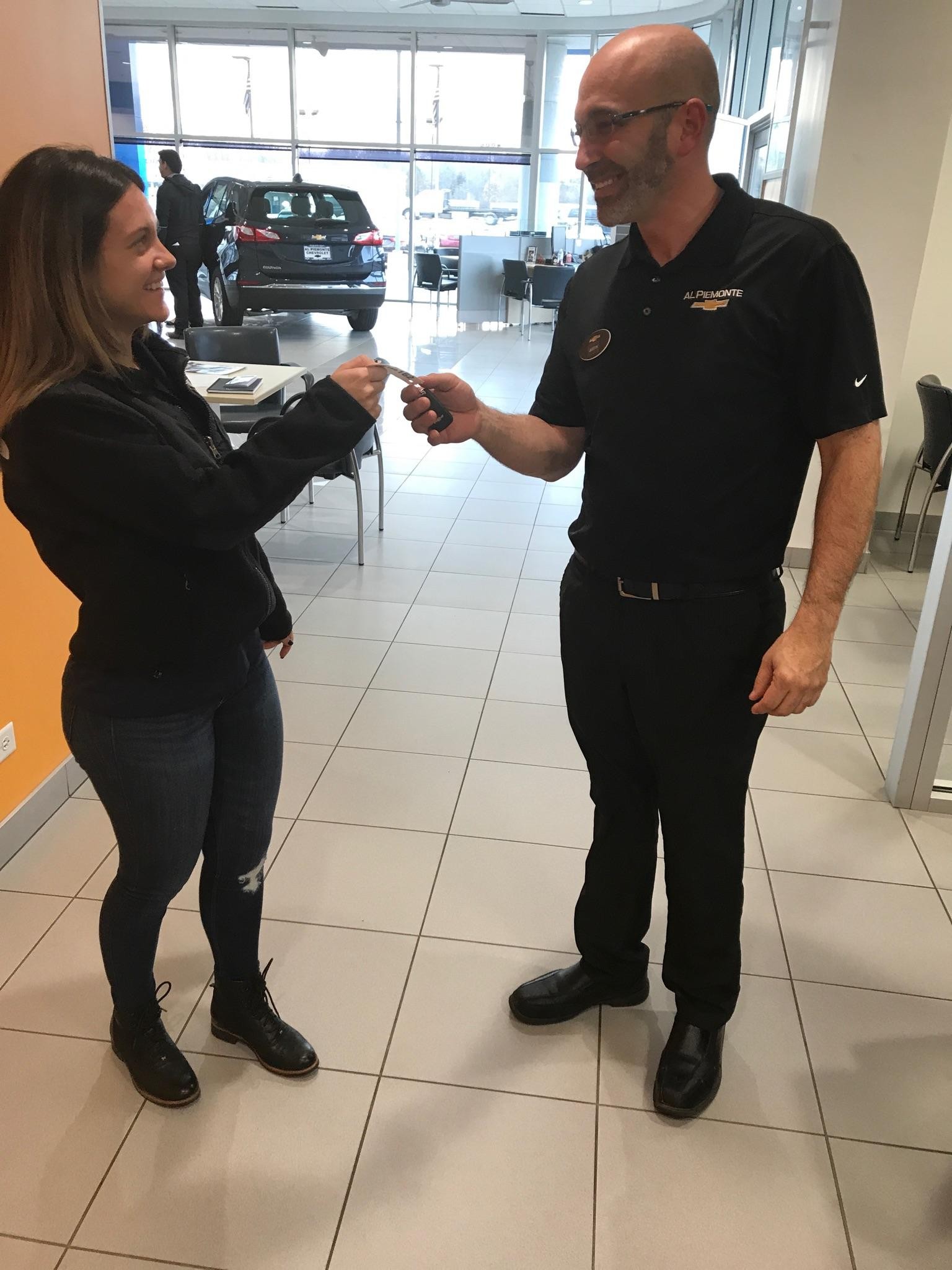 Chevrolet Certified Service Employee handing keys to women.