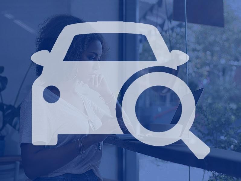Woman in dealership on laptop