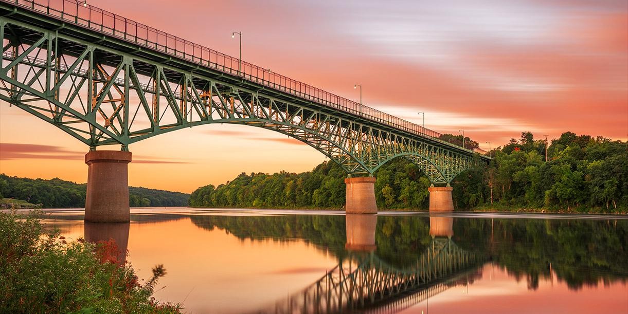 Augusta, Maine, USA view on the Kennebec River with Memorial Bridge at dawn.